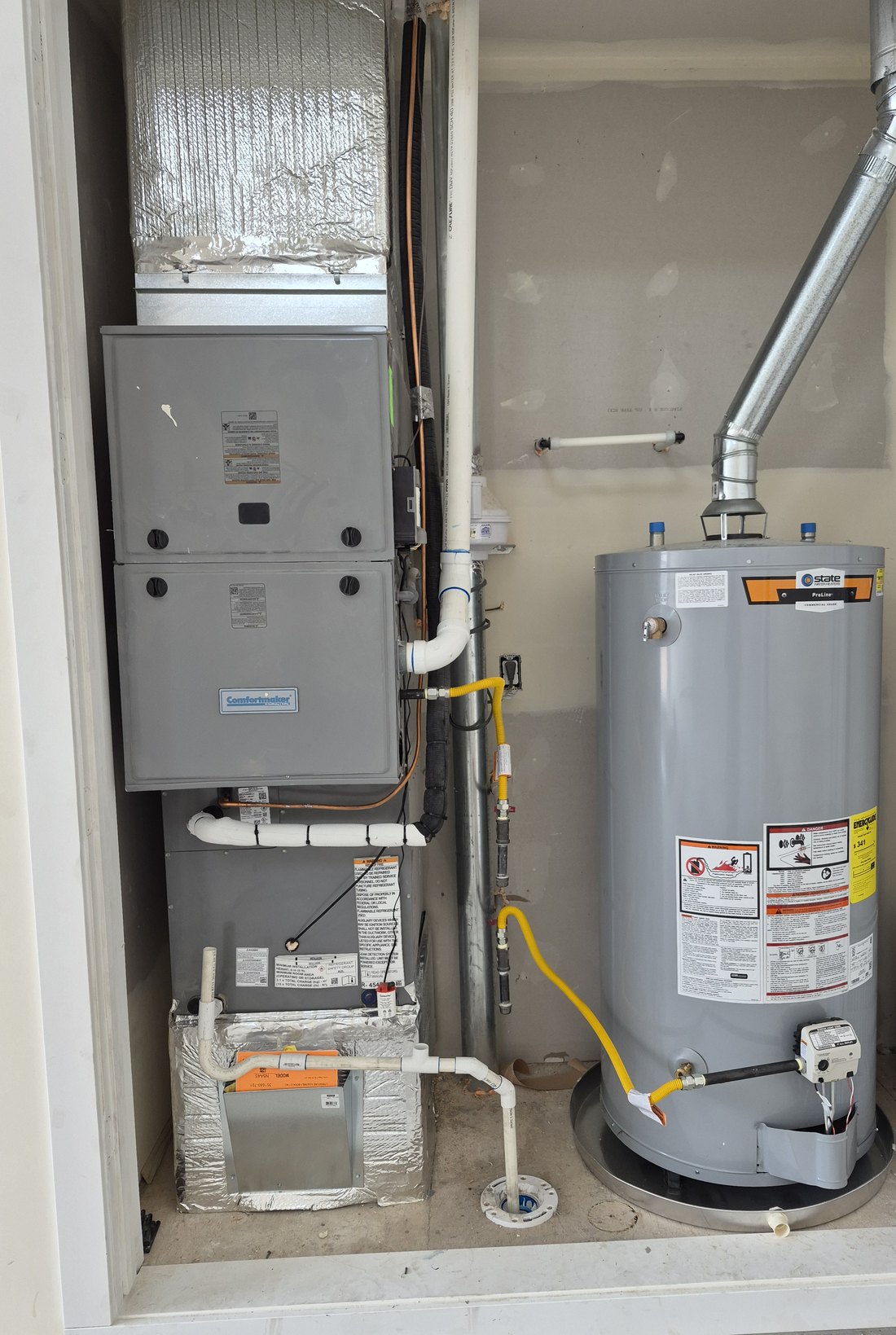 Comfortmaker gas furnace and tank water heater installed side by side in a finished mechanical closet, new build in Middleton, Idaho