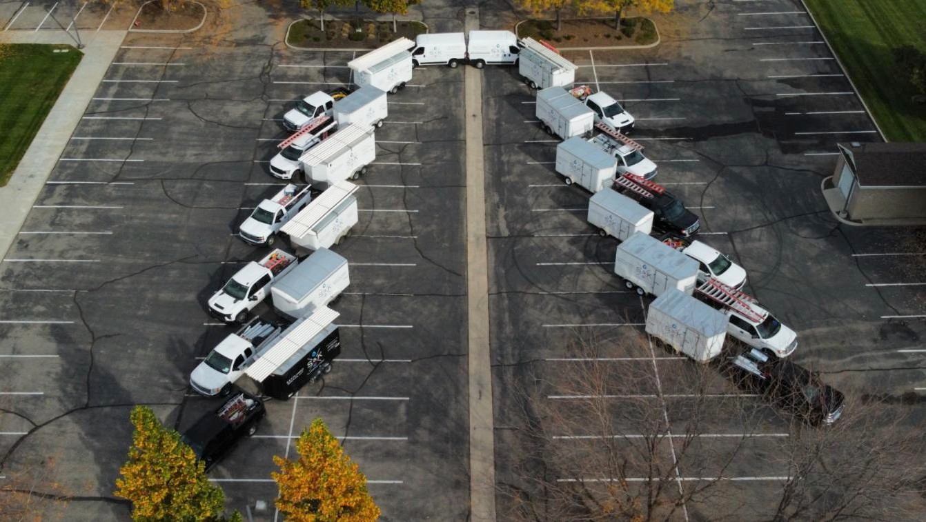 S&K Plumbing & HVAC service trucks and trailers, seen from above