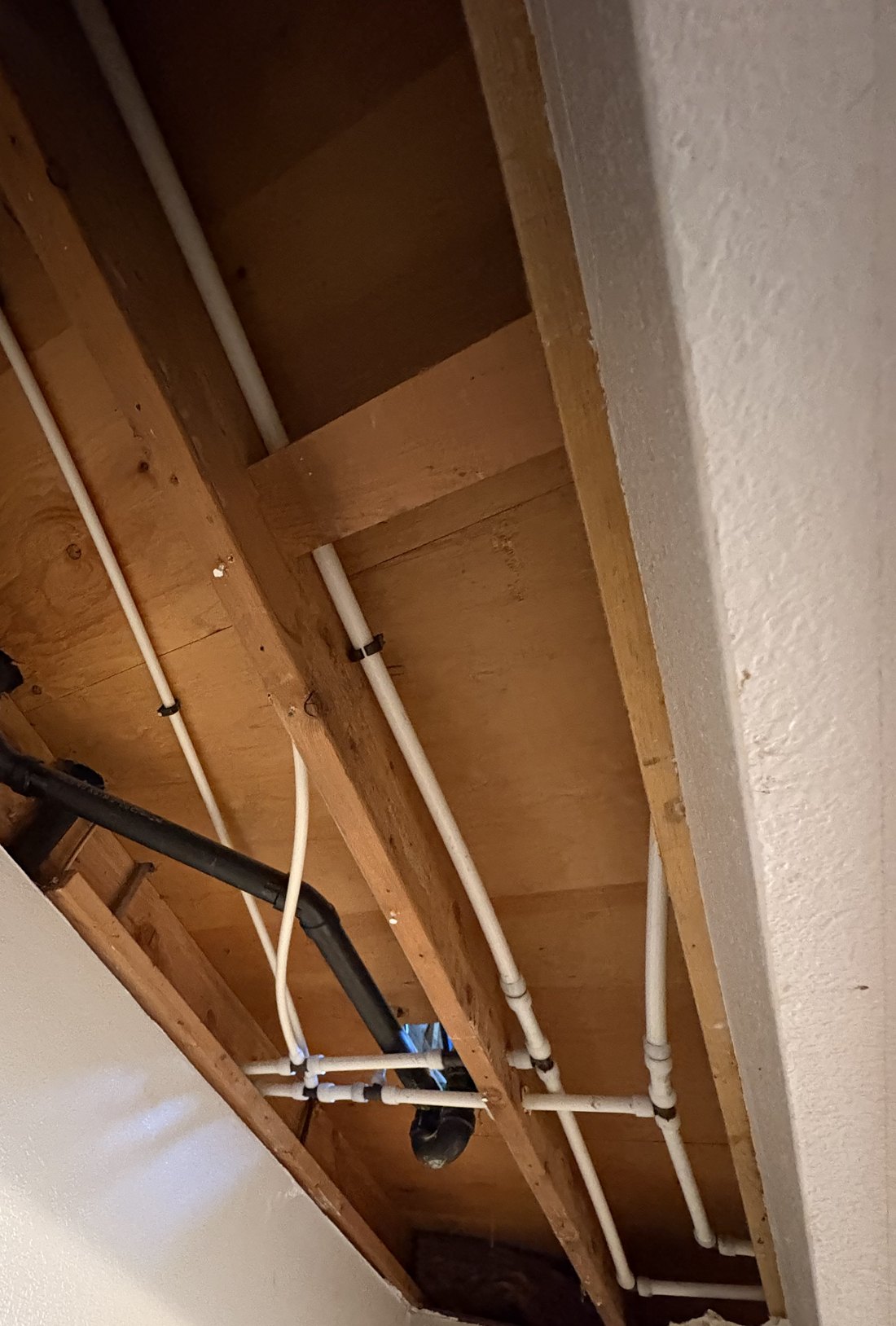 New PEX water lines run through the ceiling joists during an S&K whole-house repipe in Boise
