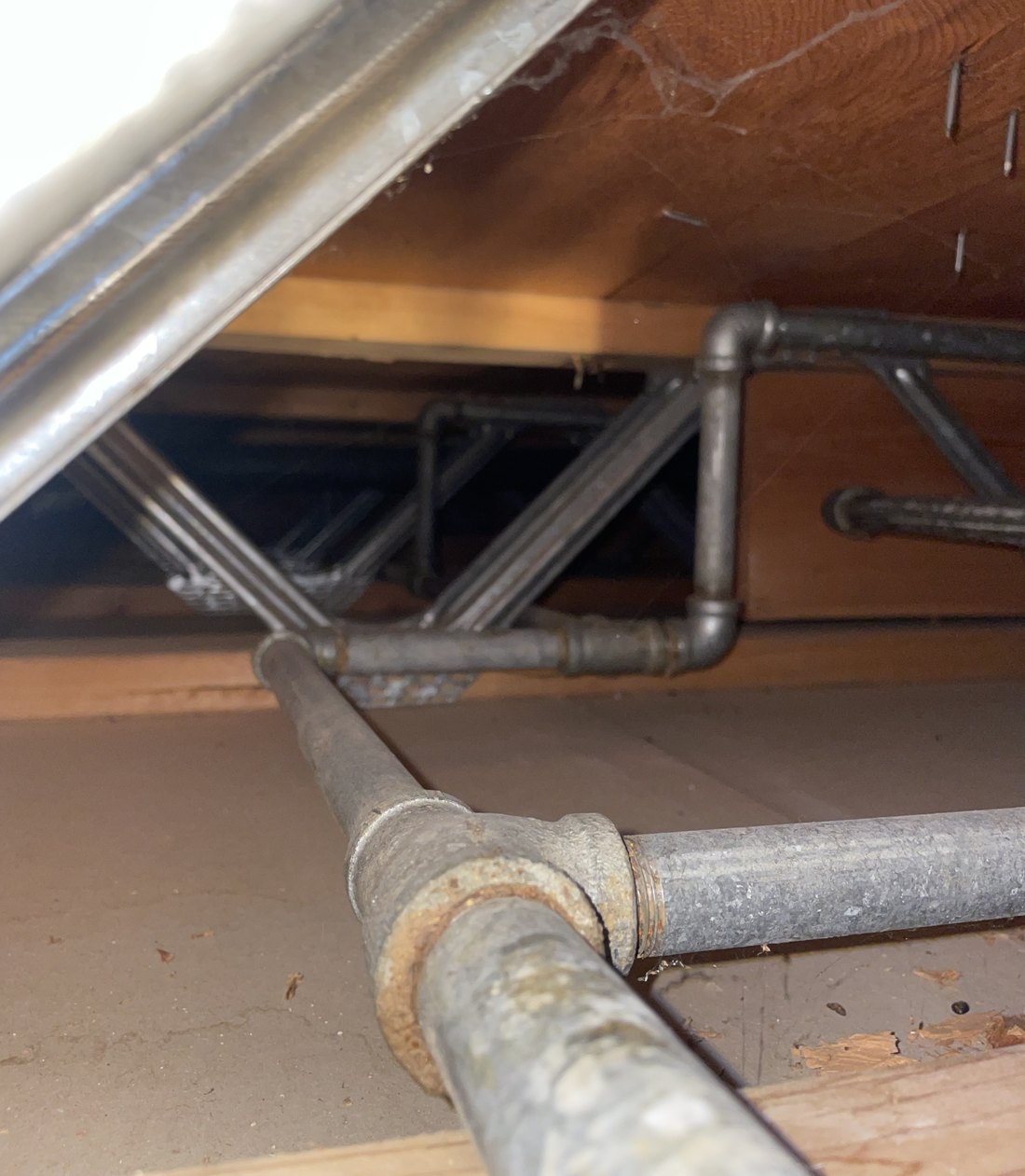 Old corroded galvanized water pipe in a Boise crawlspace before an S&K repipe